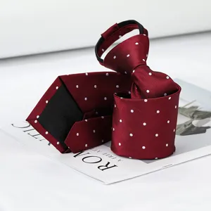 Closeup detail of burgundy zipper necktie with white polka dots, textured fabric.