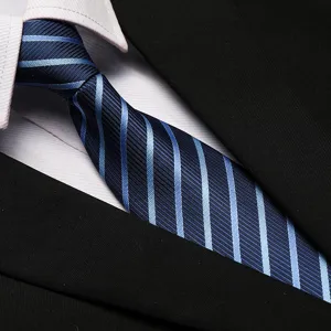Close-up detail of a classic blue striped necktie paired with white shirt and black suit.