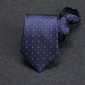 Close-up detail of dark blue men's business formal necktie with elegant geometric pattern design.