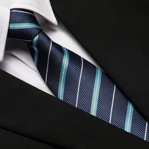 Close-up detail of the elegant blue striped business tie, showing exquisite fabric texture.
