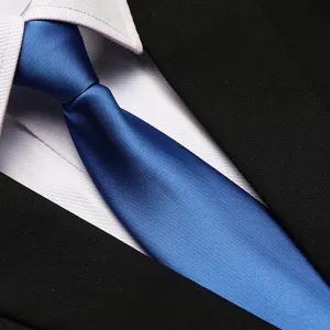 Detail shot of a classic blue business formal necktie paired with white shirt and suit.
