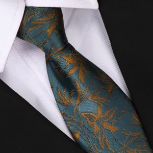 Detail shot of retro floral patterned necktie in dark green with gold leaf motifs for formal wear.