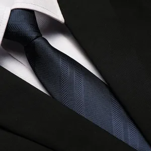 Close-up detail shot of a classic navy blue striped business necktie paired with a shirt.