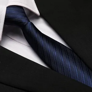 Detail shot of dark blue striped necktie showing fine texture, matching formal business attire.