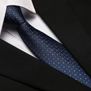 Detailed shot of a classic dark blue patterned business necktie with white shirt and suit.