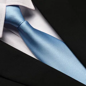 Close-up detail of the classic light blue striped tie texture, elegant professional suit accessory.