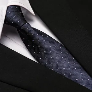 Detailed view of a professional blue patterned business tie paired with a crisp shirt collar and suit.