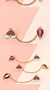 Close-up details of creative rainbow cloud and hot air balloon metal brooch chain set.