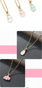 Cute cartoon pendant necklace featuring milk jar and smiling cloud charms on gold chain.