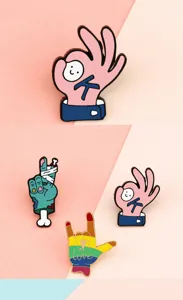 Close-up detail of cute cartoon hand gesture enamel pins, featuring vibrant colorful alloy designs.