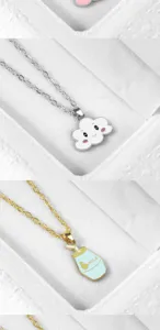 Detailed view of cute cartoon cloud and milk bottle pendant necklaces with delicate chains.