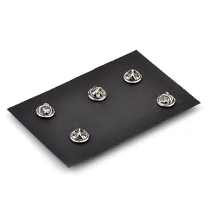 Detail view of the metal butterfly clutch backings on a black display card for alloy pins.