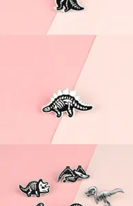 Detailed view of creative black and white alloy dinosaur skeleton enamel brooches.