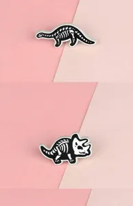 Details of creative black and white alloy dinosaur skeleton enamel pin brooch badge accessory.