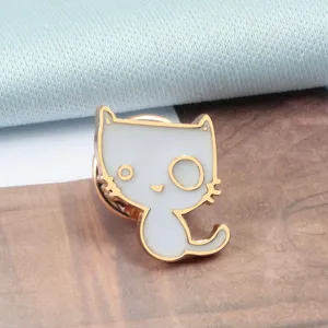 Cute white cat enamel lapel pin detail view, featuring gold trim and unique eyes design.