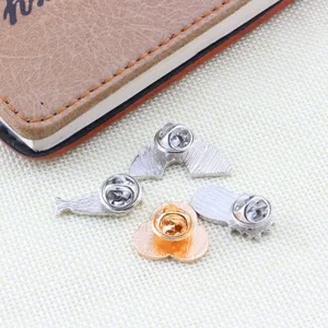 Detailed view of the back of cute cartoon enamel pins, showing alloy metal butterfly clutches.