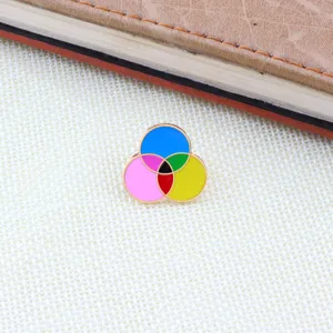 Metal enamel pin featuring a colorful CMYK color mixing design. Perfect for clothing bags.