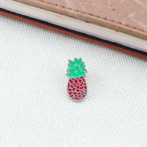 Charming pineapple enamel pin crafted with vibrant red and green colors, perfect for bags and hats.