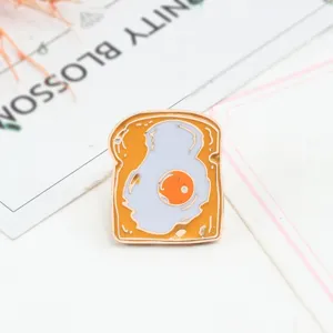 Cute cartoon fried egg toast enamel pin, stylish alloy lapel badge for jackets and bags.