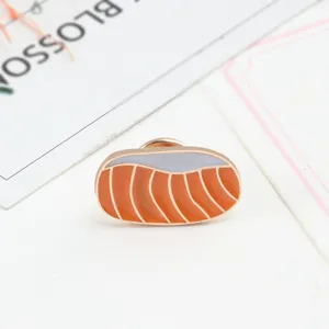 Salmon sushi enamel pin brooch, cute food badge detail shot for clothing decoration.
