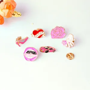 Detailed shot of pink enamel lapel pins, including sports car, lips, rose, and MOM heart.