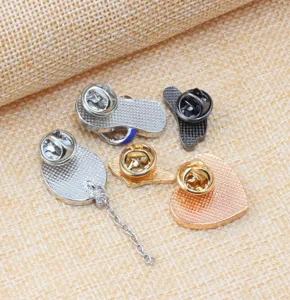Detailed view of alloy enamel brooch backs, featuring summer holiday beach theme designs.