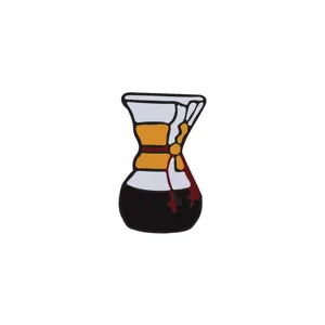 Close-up detail of a retro coffee maker shaped enamel brooch pin with a wooden collar.