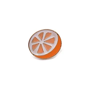 Orange slice enamel pin detail shot, featuring white and orange details with gold tone.