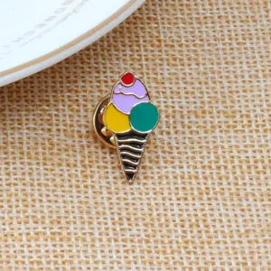 Detailed close-up shot of a colorful ice cream enamel lapel pin placed on a woven fabric mat.