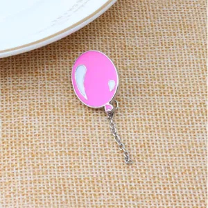 Pink balloon enamel lapel pin brooch with dangling chain detail for cute clothing accessories.