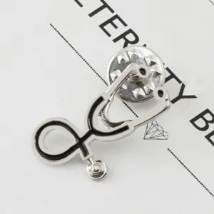 Detailed close-up of a stylish metal stethoscope lapel pin, perfect for doctor uniform decoration.