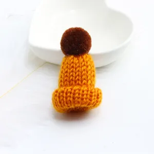 Mini knitted hat brooch charm, cute yellow yarn beanie with brown pom-pom detail.