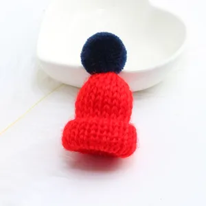 Cute red knitted hat brooch with blue pom pom, sweet style apparel badge and bag pendant accessory.