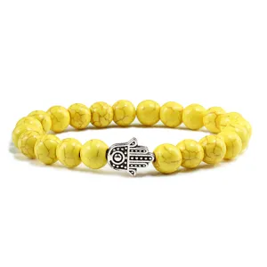 Bracelet en perles de turquoise jaune avec charm main de Hamsa bijou de yoga tendance