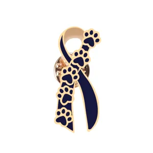 Detailed close-up of cute pet dog paw print ribbon enamel lapel pin with gold trim.