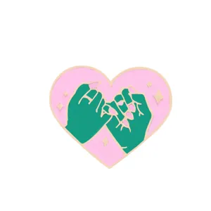 Pink heart enamel pin featuring pinky promise green hands design, cute metal brooch for bags.