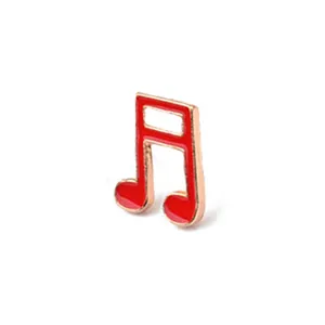 Enamel red musical note lapel pin brooch badge, cute alloy musical accessory detail shot.