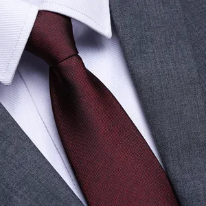 Men's business suit tie, classic burgundy red texture for formal wedding wear today.