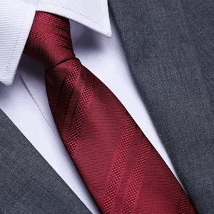 Detailed close-up of a classic red textured men's formal necktie for business and wedding.