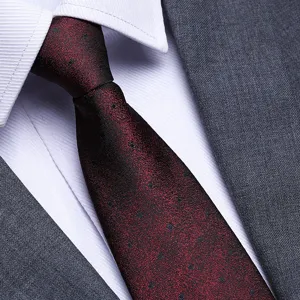 Close-up detail of men wine red polka dot tie texture with white shirt and suit.