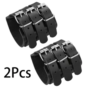 Detail shot of black leather punk wristband with multiple silver metal pin buckles.