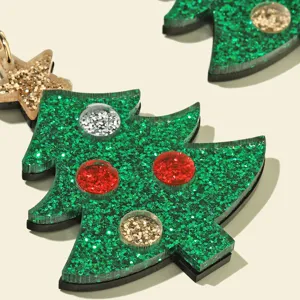 Detailed shot of glittering green acrylic Christmas tree earrings, festive holiday jewelry accessory