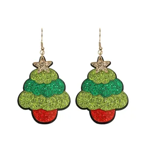 Sparkling acrylic Christmas tree earrings with glitter and star top. Festive holiday jewelry.