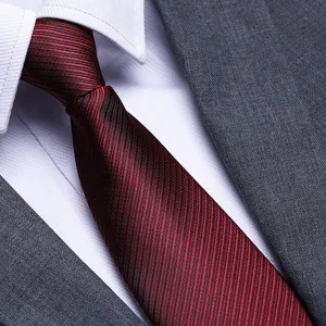Red striped men's zipper necktie with white shirt and grey suit jacket detail view photo