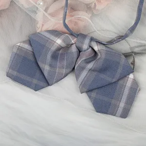 Nahaufnahme der blaugrauen karierten JK Fliege, süßes Schulstil Schleifen Zubehör für Uniform.