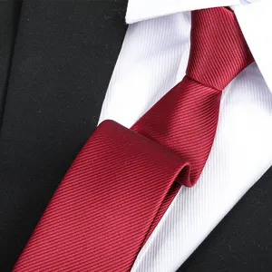 Close-up detail shot of a classic burgundy textured silk tie, perfect for business formal wear.
