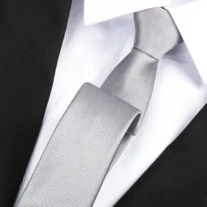 Detailed shot of a stylish grey formal business necktie paired with crisp shirt.