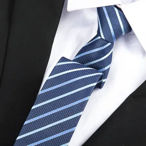 Close-up detail shot of the elegant blue diagonal striped necktie paired with crisp shirt.