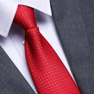 Red textured necktie close-up, premium business formal tie detail for men suit and shirt.