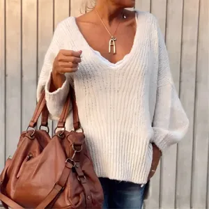 Detail shot of a casual V-neck knit sweater featuring chunky ribbed texture and cozy loose fit.